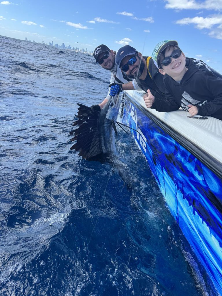 Releasing a sailfish with the Miami skyline in the background