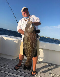 Angler holding a trophy sized black grouper