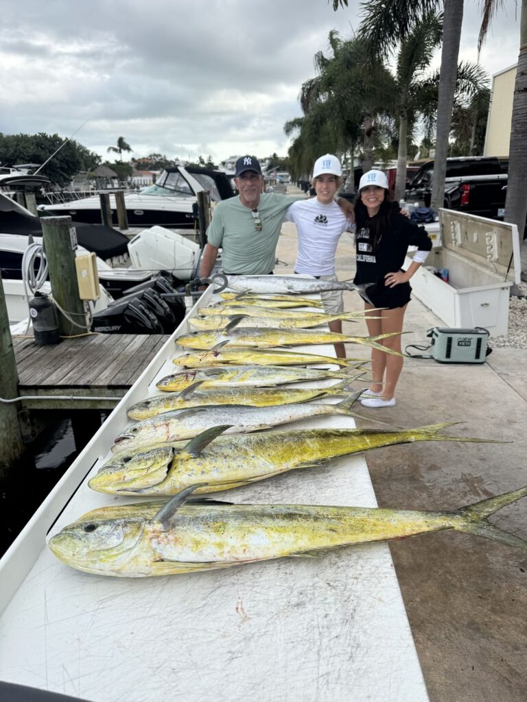 Happy anglers at the dock with the day's catch of mahi and kingfish.